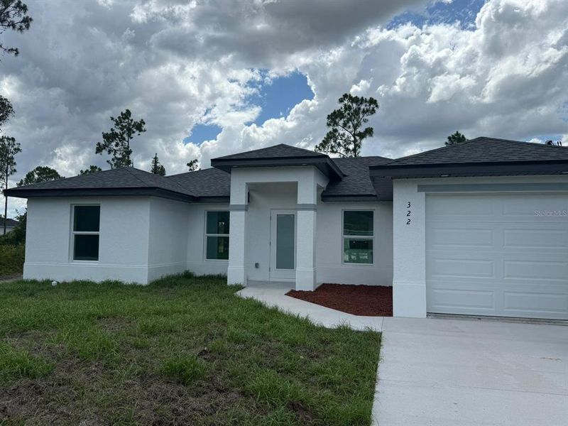 Front exterior of a new home in , Lehigh Acres, FL, highlighting curb appeal (Image 13). Front exterior of a new home in , Lehigh Acres, FL, highlighting curb appeal (Image 13).