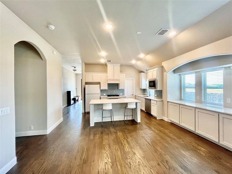 Kitchen featuring decorative backsplash, hardwood / wood-style floors, and stainless steel appliances