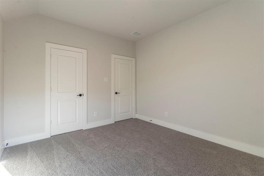 Unfurnished bedroom with carpet and baseboards