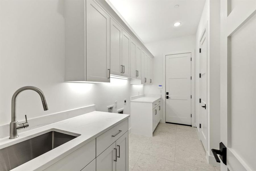 Sink and second pantry in laundry as well as mudroom with hooks Sink and second pantry in laundry as well as mudroom with hooks