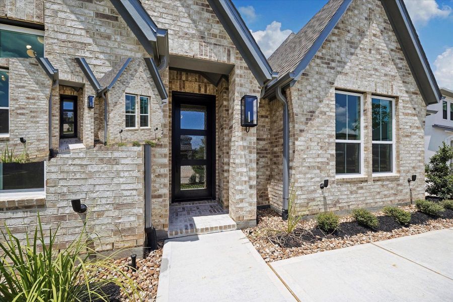 Exterior details and patio area of a home in Grand Central Park, Conroe (Image 30).