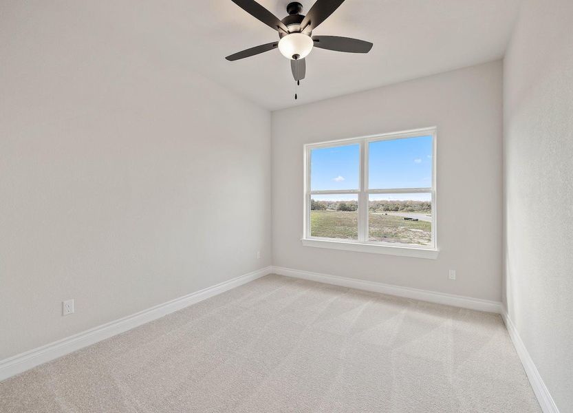 Spare room featuring light colored carpet, ceiling fan, and baseboards Spare room featuring light colored carpet, ceiling fan, and baseboards