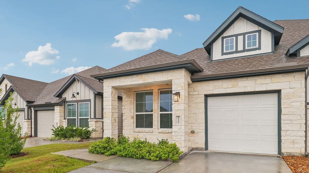 Front exterior of a new home in Meridiana Townhomes, Manvel, TX, highlighting curb appeal (Image 25).