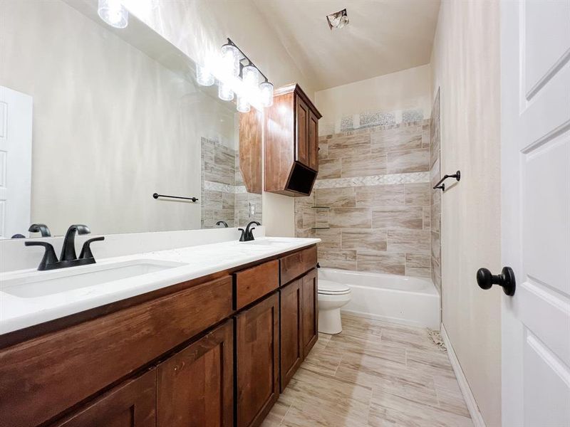 Full bath featuring double vanity and shower / bathtub combination with curtain Full bath featuring double vanity and shower / bathtub combination with curtain