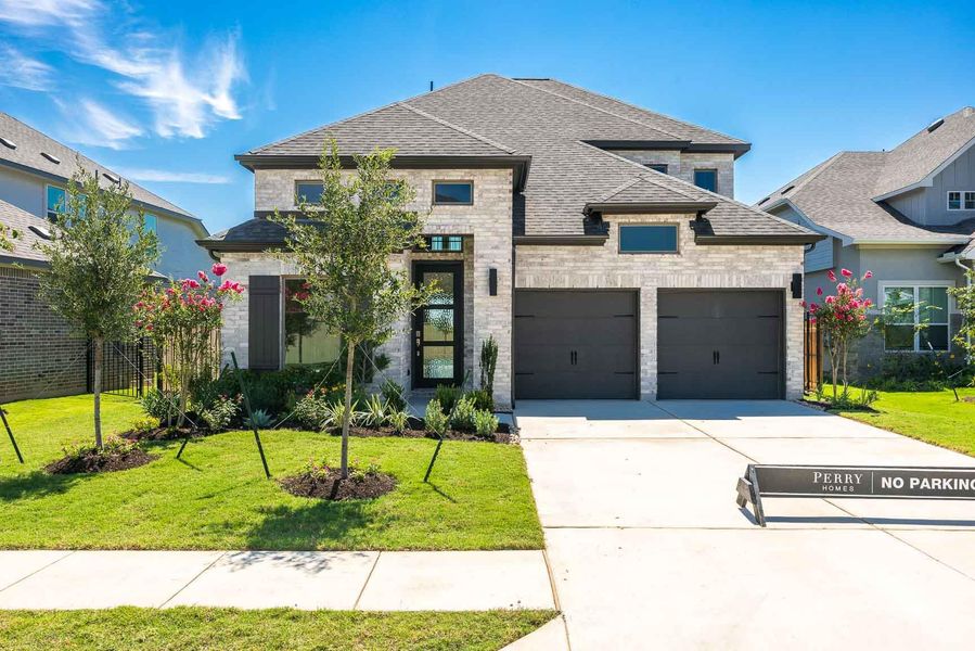 View of front of property with roof with shingles, a front yard, concrete driveway, and a garage