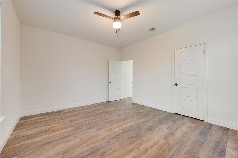 Unfurnished room with ceiling fan and light hardwood / wood-style flooring