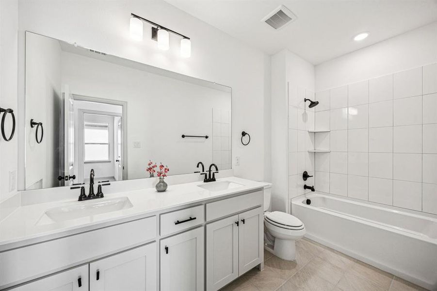 Friends and family will enjoy this thoughtfully designed guest bath offering space for two. Friends and family will enjoy this thoughtfully designed guest bath offering space for two.