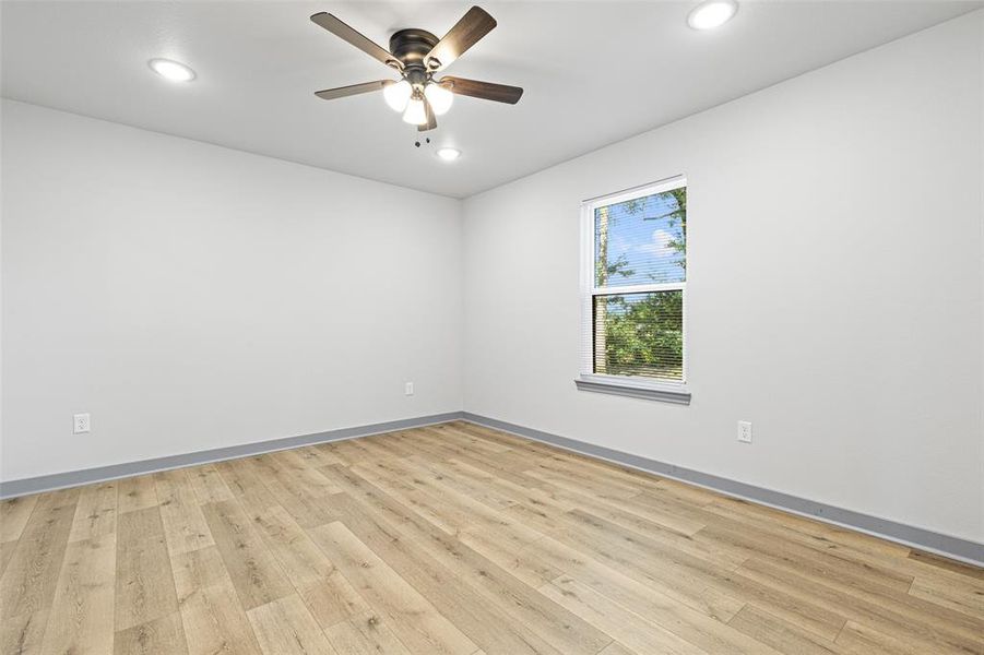 Spare room with light wood-type flooring, recessed lighting, and a ceiling fan Spare room with light wood-type flooring, recessed lighting, and a ceiling fan