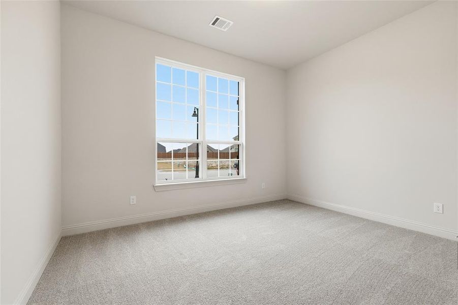 Empty room with light colored carpet