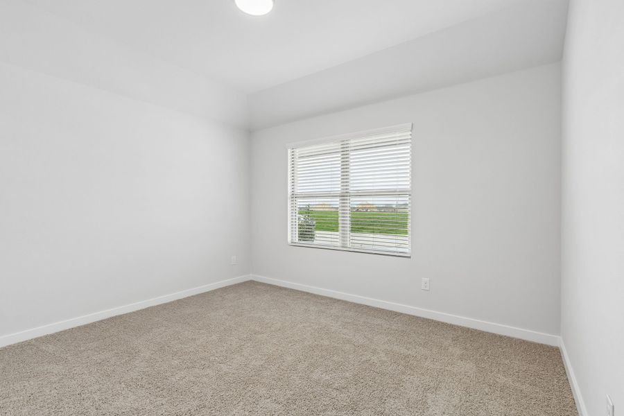Bedroom in the Oscar home plan by Trophy Signature Homes – REPRESENTATIVE PHOTO