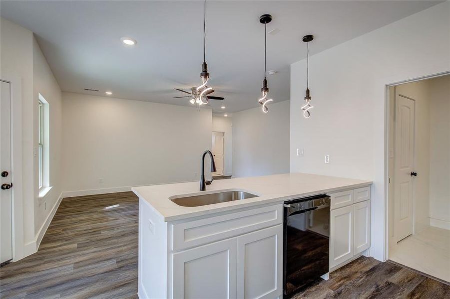 Kitchen with a peninsula, dark wood-style flooring, dishwasher, decorative light fixtures, and recessed lighting Kitchen with a peninsula, dark wood-style flooring, dishwasher, decorative light fixtures, and recessed lighting