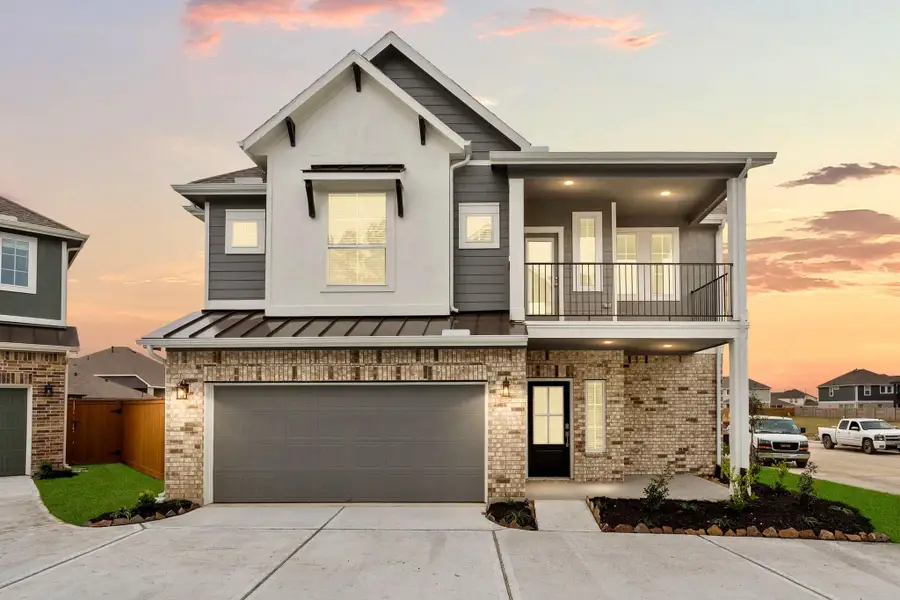 Front exterior of a new home in Elyson, Katy, TX, highlighting curb appeal (Image 2). Front exterior of a new home in Elyson, Katy, TX, highlighting curb appeal (Image 2).