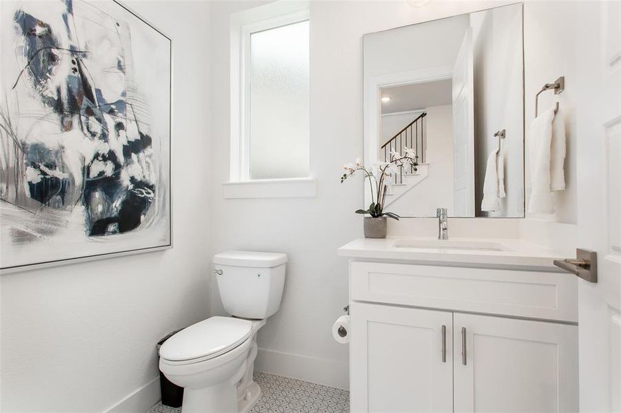 Bathroom with tile patterned floors, toilet, and vanity