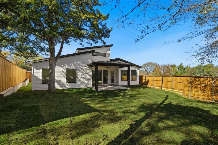 Back of house with a ceiling fan, a fenced backyard, and a patio Back of house with a ceiling fan, a fenced backyard, and a patio