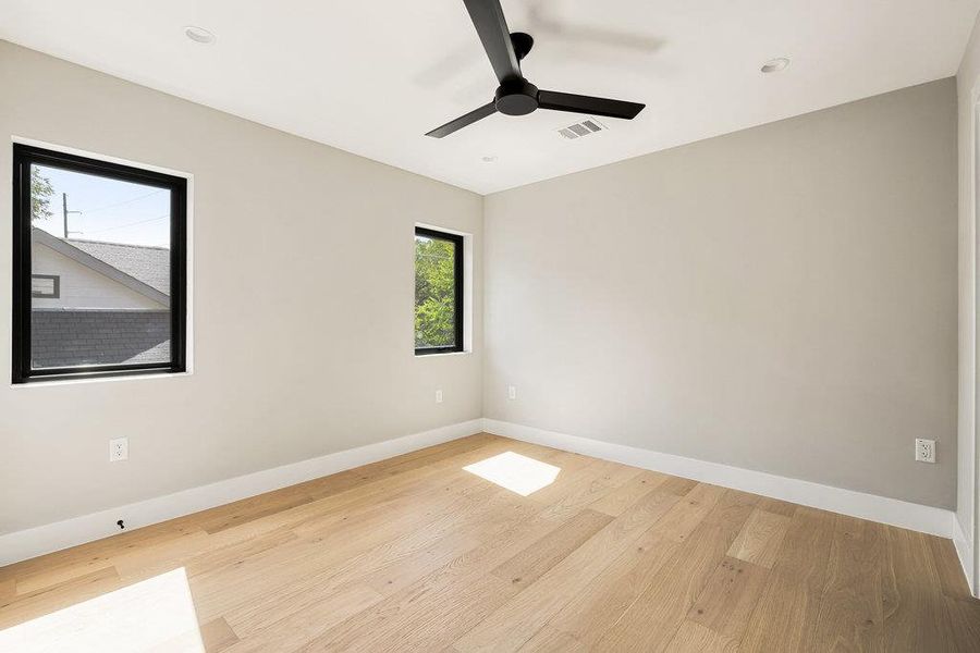 Spare room with light wood finished floors, ceiling fan, and recessed lighting