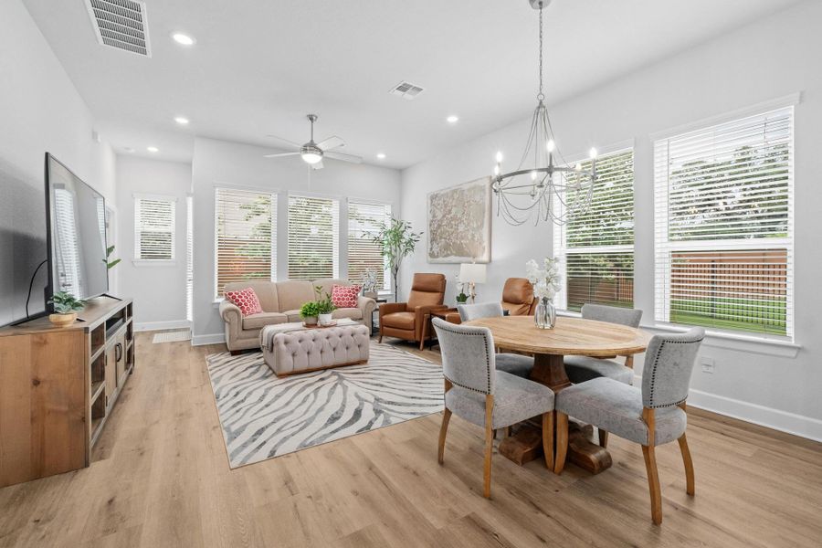 Dining space featuring baseboards, light wood finished floors, and visible vents Dining space featuring baseboards, light wood finished floors, and visible vents
