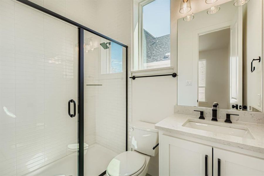Full bath featuring vanity and a shower stall Full bath featuring vanity and a shower stall