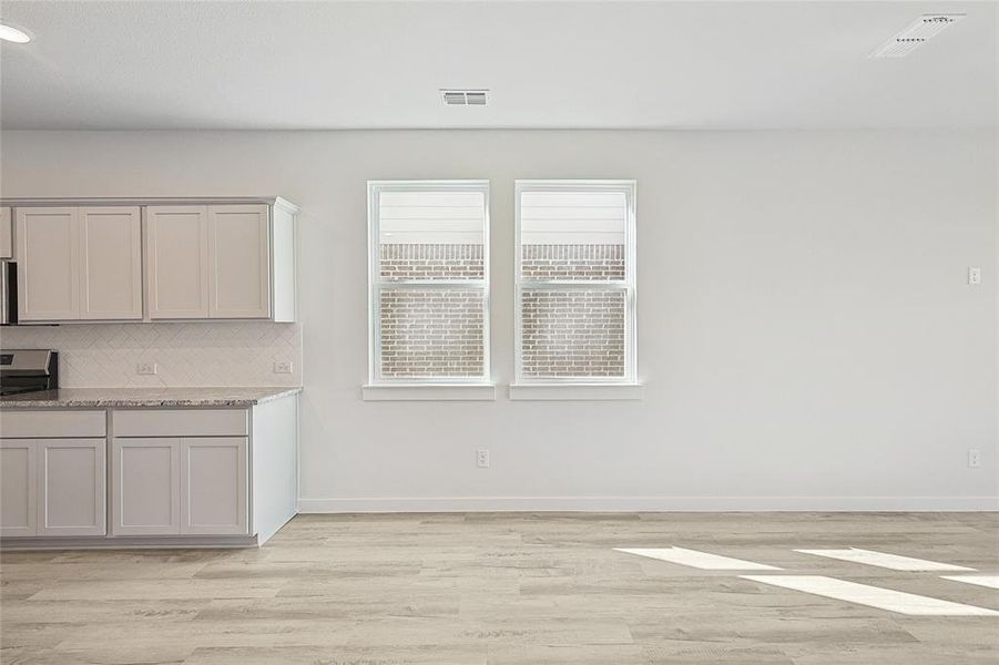 Unfurnished dining area featuring light hardwood / wood-style floors