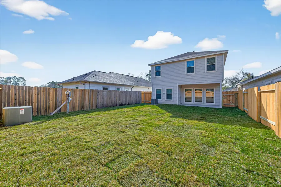 Exterior details and patio area of a home in Woodland Lakes, Houston (Image 26).