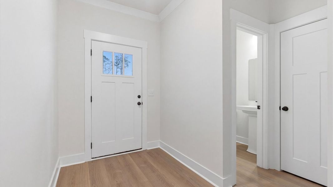 Highly functional foyer with hardwood flooring that flows seamlessly into living spaces located at Pelham Crossing