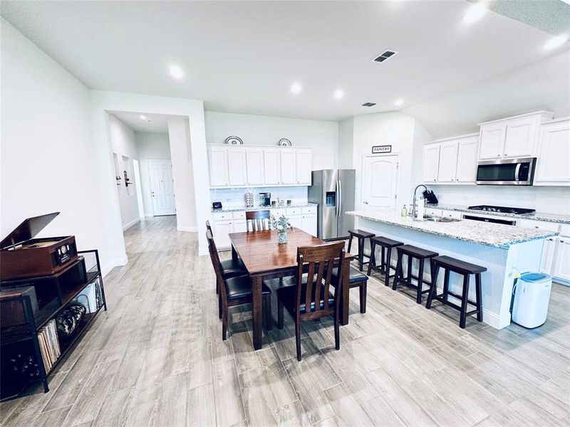 Dining area featuring sink and light hardwood / wood-style flooring