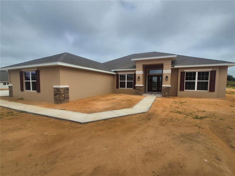 Front exterior of a new home in Hill Country Estates, Dade City, FL, highlighting curb appeal (Image 2). Front exterior of a new home in Hill Country Estates, Dade City, FL, highlighting curb appeal (Image 2).