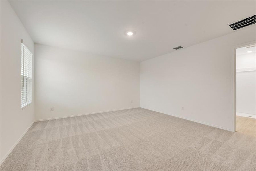 Spare room featuring light colored carpet