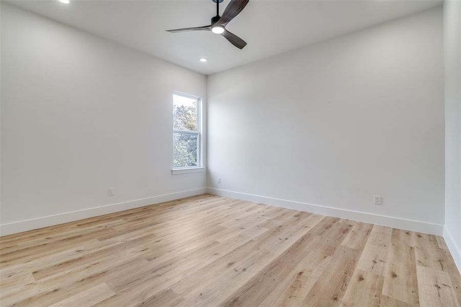 Unfurnished room with light wood-style floors, ceiling fan, and recessed lighting