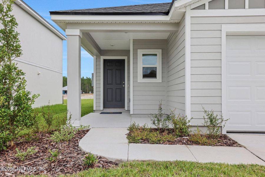 Front exterior of a new home in Bellbrooke, Jacksonville, FL, highlighting curb appeal (Image 14).