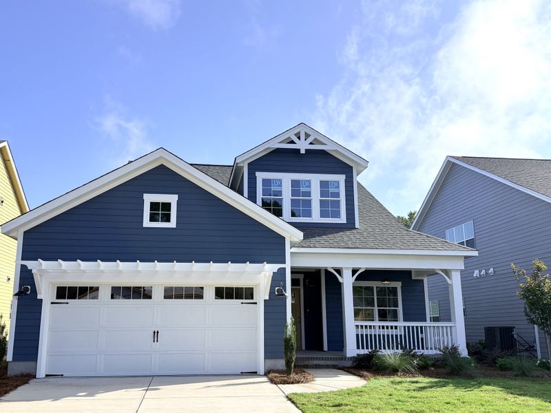 Front exterior of a new home in Riverside Cove, Wilmington, NC, highlighting curb appeal (Image 1). Front exterior of a new home in Riverside Cove, Wilmington, NC, highlighting curb appeal (Image 1).