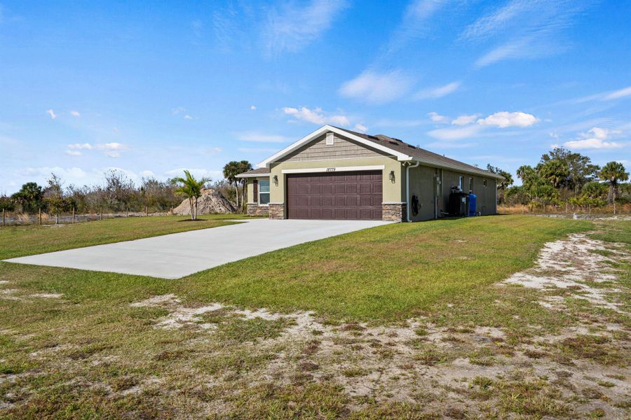 Front exterior of a new home in , Okeechobee, FL, highlighting curb appeal (Image 23).