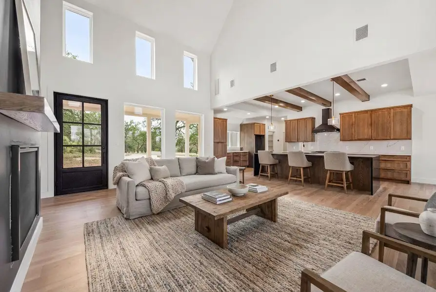 The living room’s 20+ ft vaulted ceilings create a grand entrance into the home