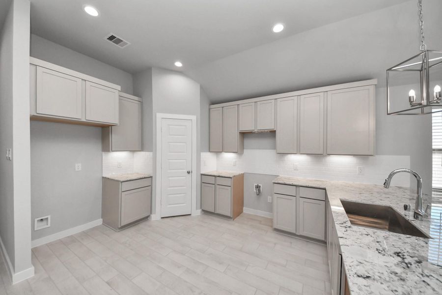 The extended counter area adds both practicality and style, making meal preparation a breeze. Every detail is thoughtfully designed to enhance the kitchen's functionality and aesthetic appeal. Sample photo of completed home with similar floor plan. Actual colors and selections may vary.