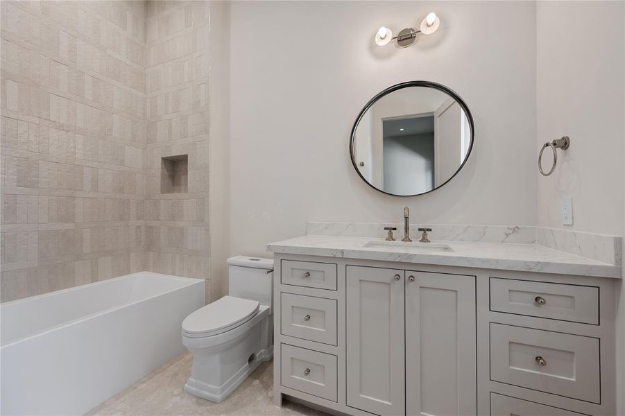 One of the upstairs secondary bathrooms with a shower / bath combo.