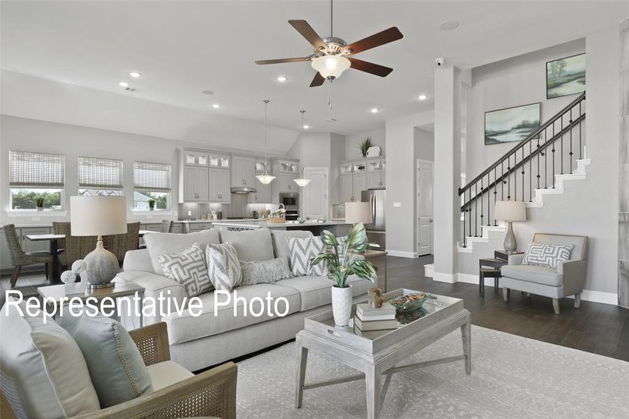 Living room featuring wood-type flooring and ceiling fan