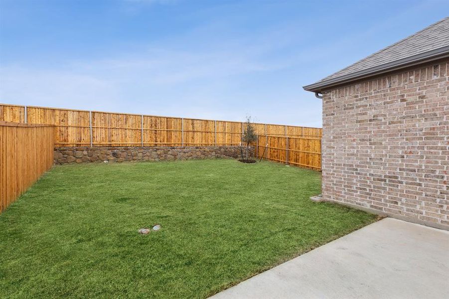 Backyard in the Elm home plan by Trophy Signature Homes – REPRESENTATIVE PHOTO