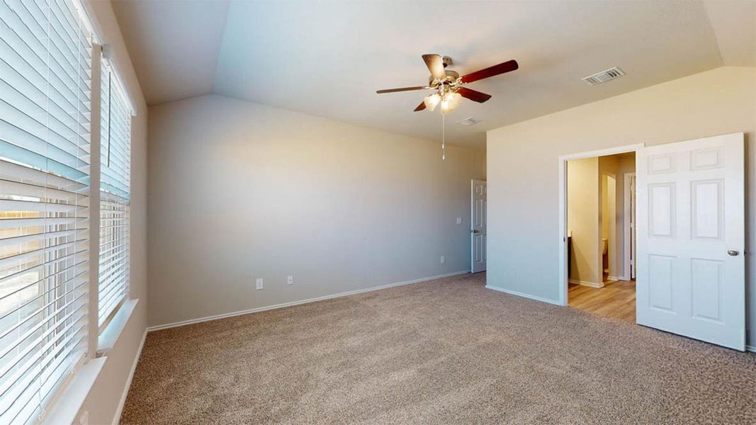 Unfurnished bedroom with lofted ceiling, light carpet, and ceiling fan