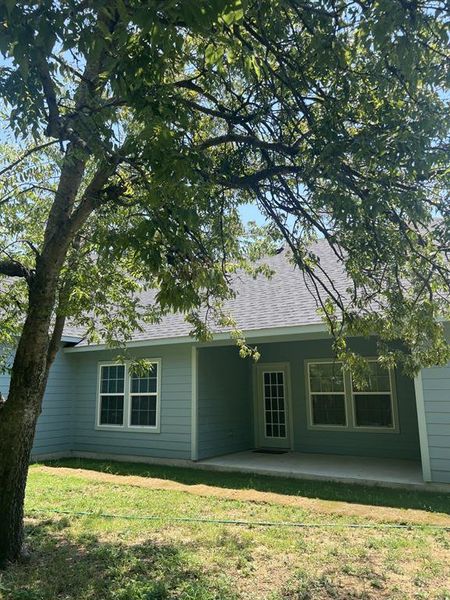 Back of property with roof with shingles, a yard, and a covered porch. Back of property with roof with shingles, a yard, and a covered porch.
