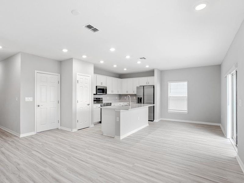 Downstairs, enjoy a welcoming, open-concept living area - Blakely by Highland Homes Downstairs, enjoy a welcoming, open-concept living area - Blakely by Highland Homes