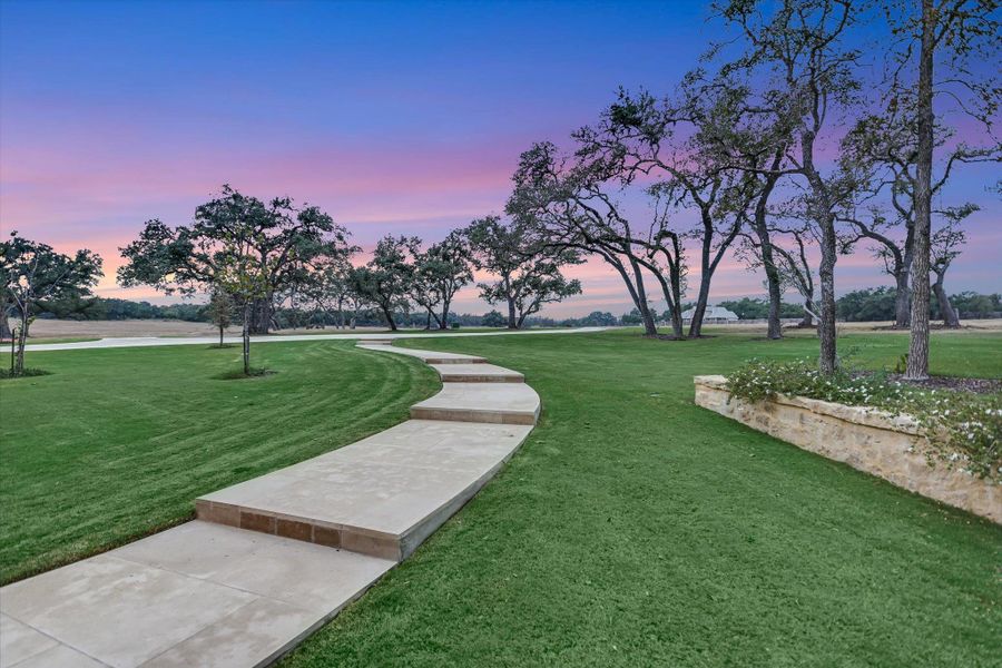 View of home's community with a lawn View of home's community with a lawn