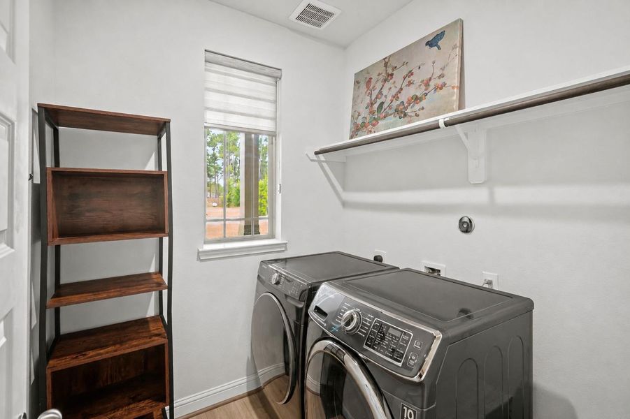 Spacious utility room offers room for additional cabinetry, shelving, and an extra refrigerator or freezer.