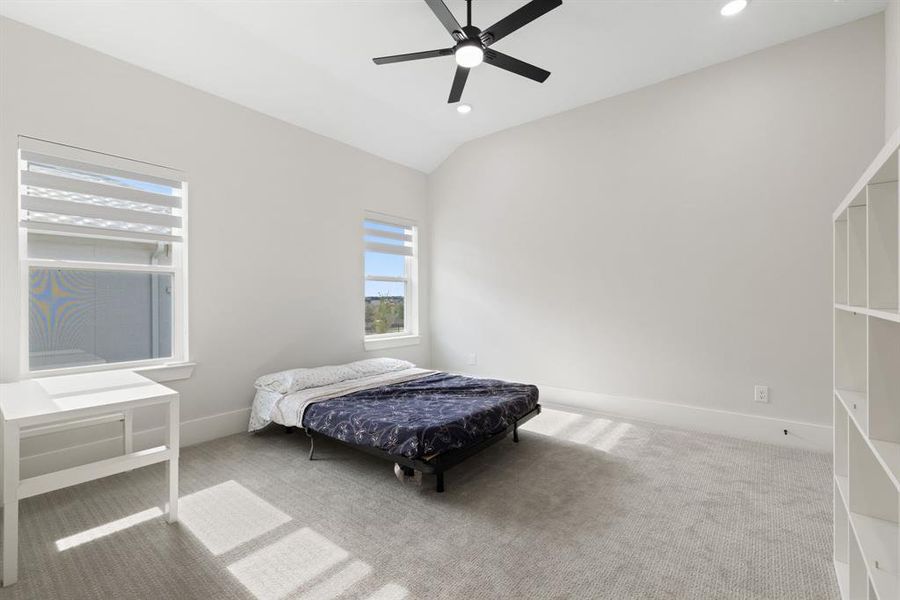 Bedroom featuring vaulted ceiling, carpet floors, recessed lighting, and a ceiling fan