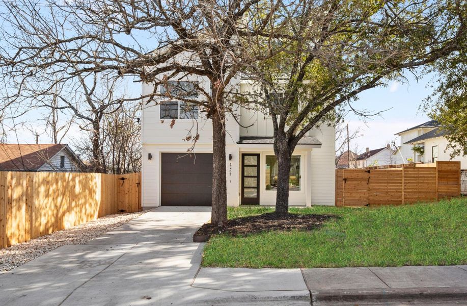 View of front of home with fence and driveway