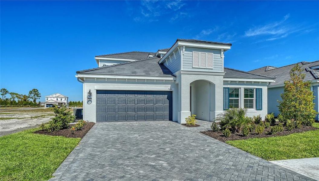 Front exterior of a new home in Windward, Sarasota, FL, highlighting curb appeal (Image 1). Front exterior of a new home in Windward, Sarasota, FL, highlighting curb appeal (Image 1).