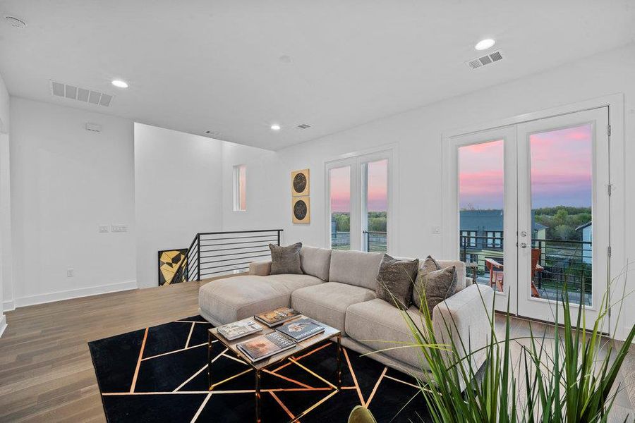 Living area featuring wood finished floors, french doors, and recessed lighting