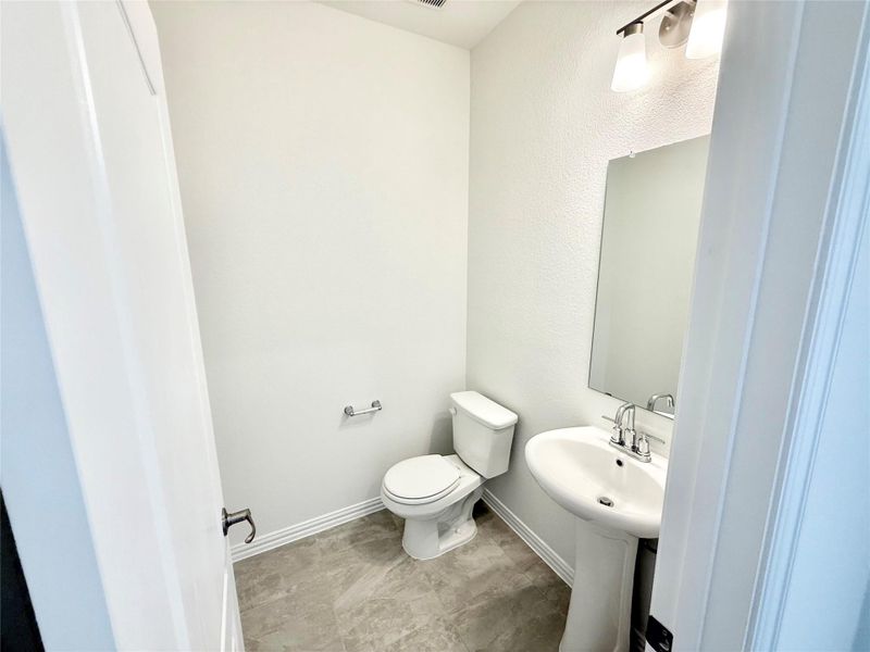 Half bathroom with toilet and baseboards Half bathroom with toilet and baseboards