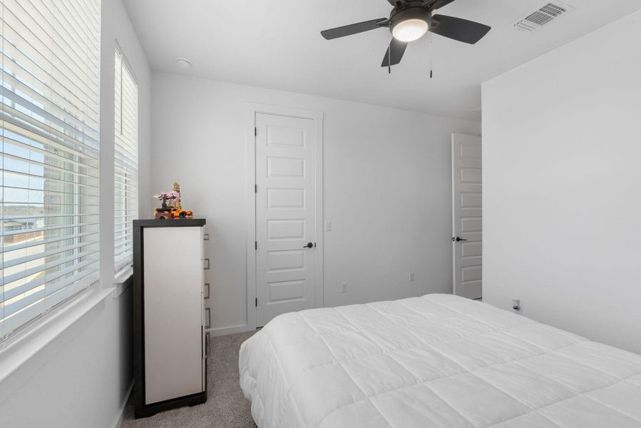 Bedroom 4 featuring a ceiling fan and visible vents