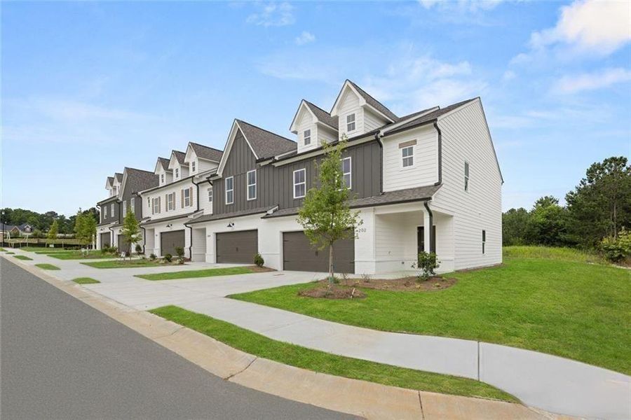 Front exterior of a new home in , Loganville, GA, highlighting curb appeal (Image 26).
