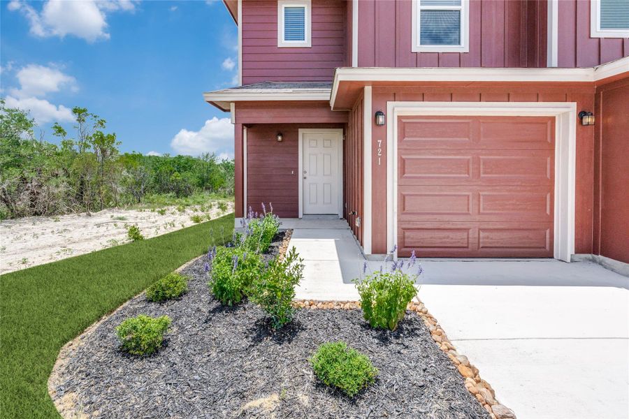 Entrance to property featuring board and batten siding, a garage, concrete driveway, and a yard Entrance to property featuring board and batten siding, a garage, concrete driveway, and a yard