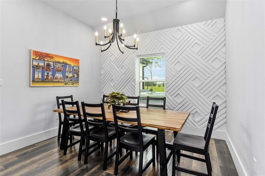 Separate dining area with dramatic accent wall and designer chandalier